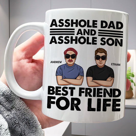 White coffee mug with cartoon dad and son wearing sunglasses and names Andrew and Ethan asshole dad and son gift