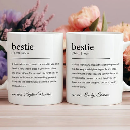 Two white bestie definition mugs with personalized names on desk floral background custom friendship gift for office