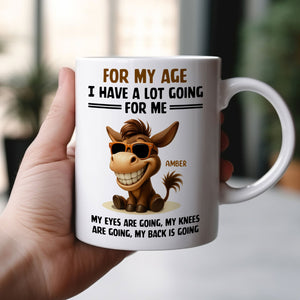White ceramic 365Gifty mug with smiling donkey and funny text for my age I have a lot going for me mug