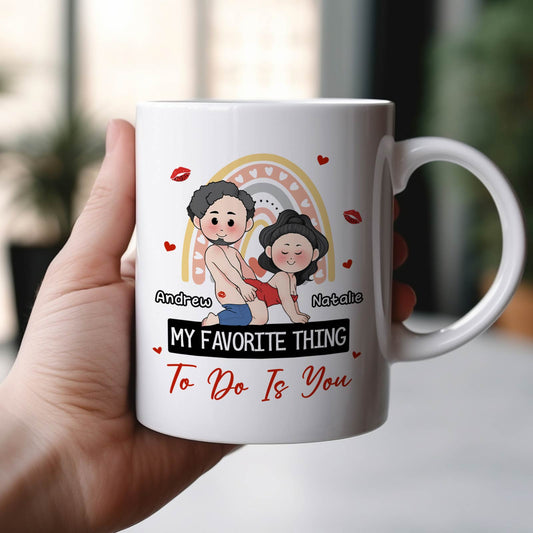 Hand holding 365Gifty white ceramic my favorite thing to do is you mug featuring cartoon couple Andrew Natalie and hearts