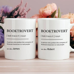 personalized booktrovert mug set of two white ceramic mugs with BOOKTROVERT definition and names James and Robert floral backdrop
