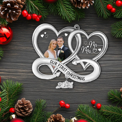 Silver personalized Christmas ornament with intertwined hearts and custom photo of couple celebrating first Christmas