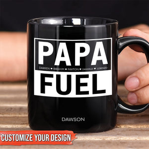 Black ceramic personalized dad mug with bold white PAPA FUEL design and custom name Dawson held in hand
