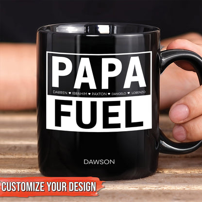 Black ceramic personalized dad mug with bold white PAPA FUEL design and custom name Dawson held in hand
