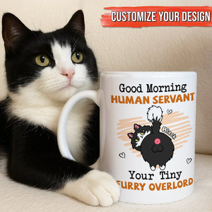 Black and white cat beside a personalized pet lover mug reading Good Morning Human Servant Your Tiny Furry Overlord