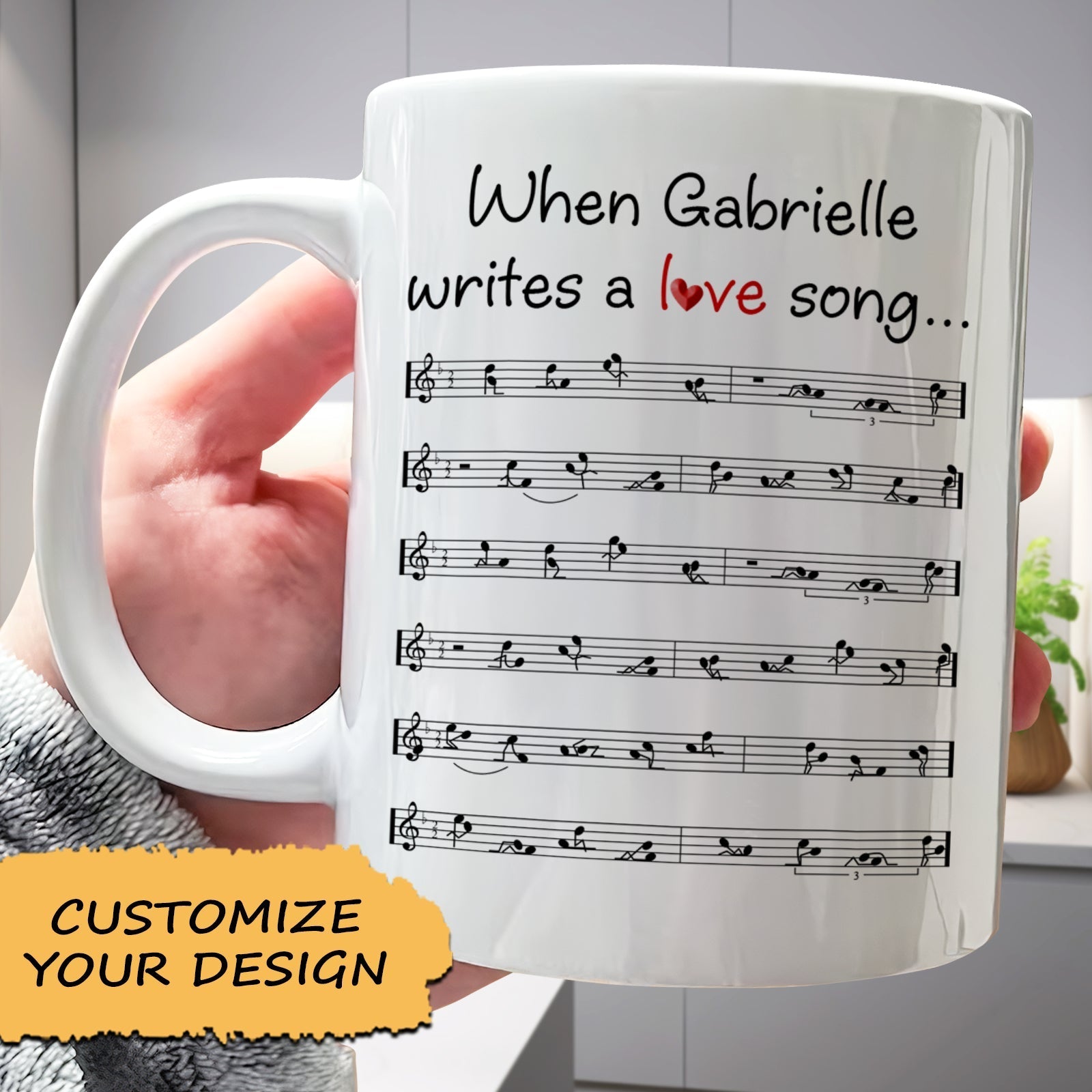 White ceramic romantic custom coffee mug featuring personalized text When Gabrielle writes a love song and printed sheet music