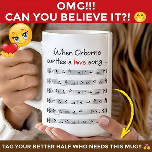 Hands holding white mug reading When Orborne writes a love song with printed sheet music romantic custom coffee mug
