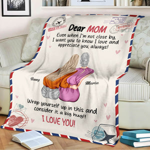 Personalized mom blanket featuring a heartfelt message and illustration of a mother-daughter embrace