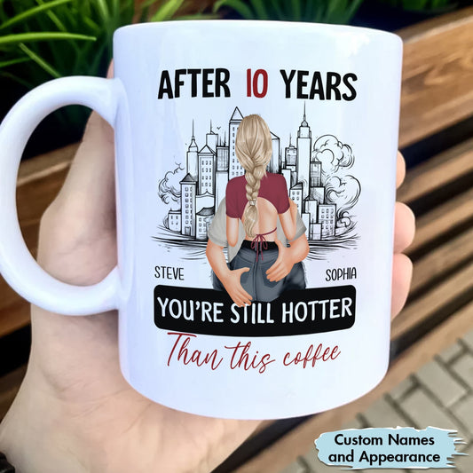 White coffee mug with after 10 years still hotter than coffee mug design featuring a couple and city background