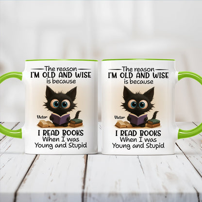 Two 365Gifty white mugs with green handles showing a wide eyed cat reading books and funny personalized accent mug for bookworms