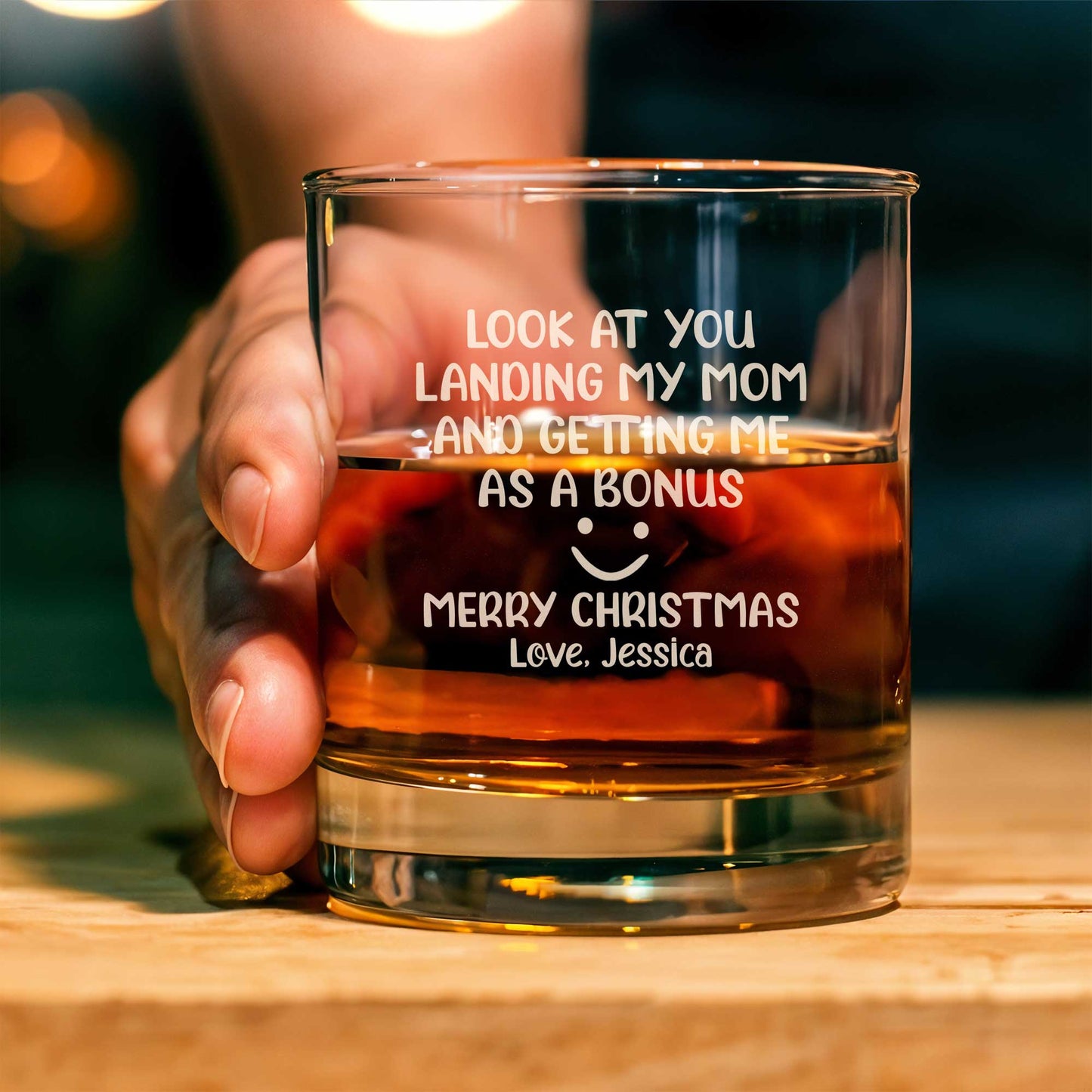 Personalized Whiskey Glass with funny Christmas message held in hand showing name Jessica and amber whiskey