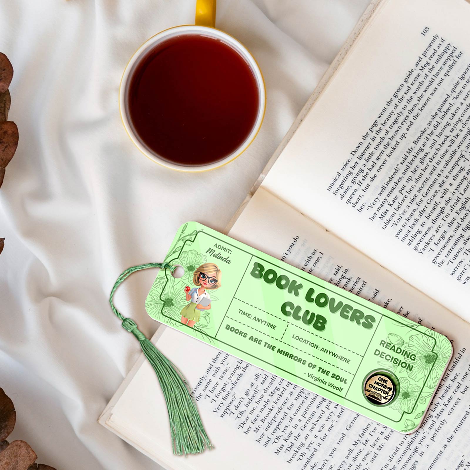 Bookmark For Book Lovers green tassel bookmark with Book Lovers Club design placed on an open book