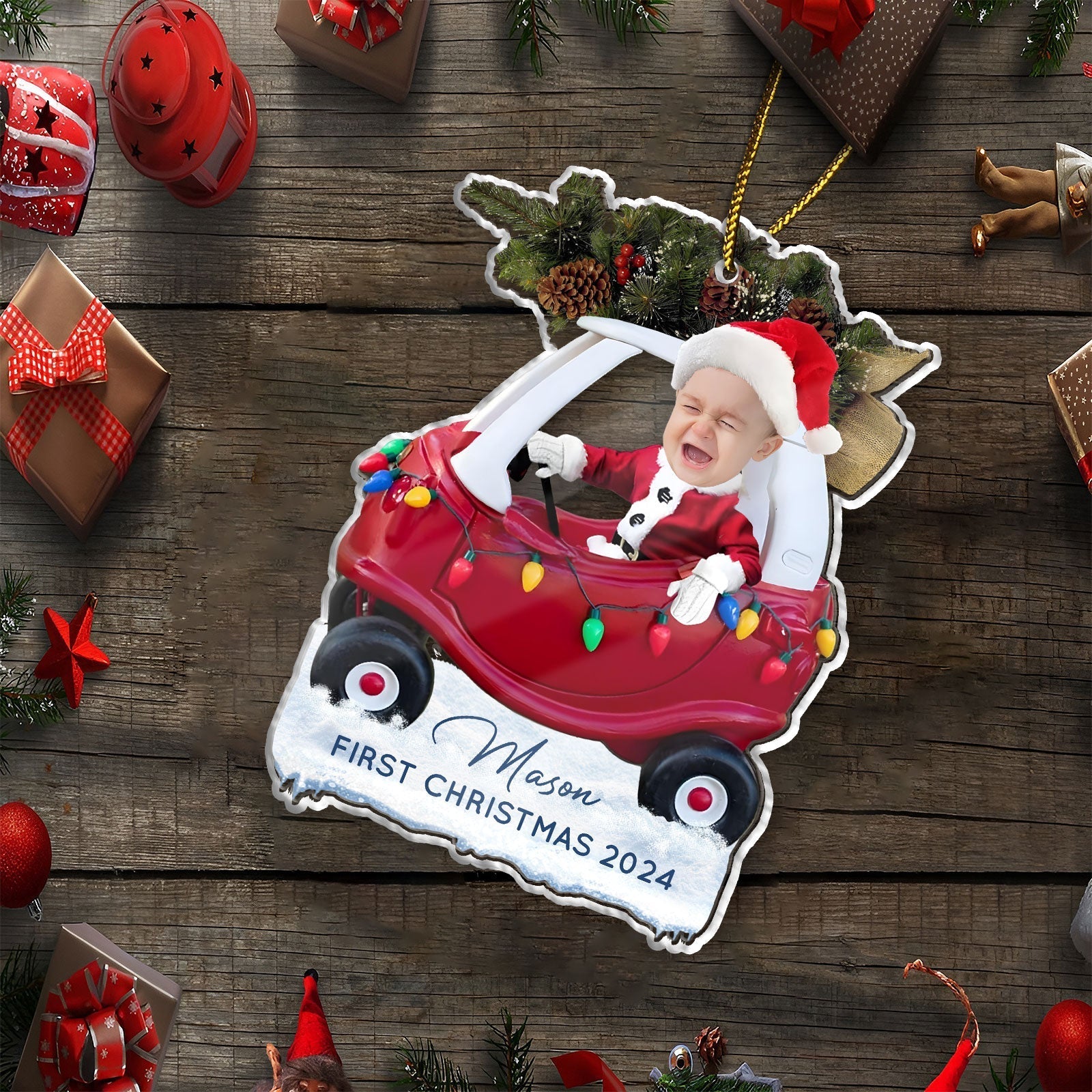 Custom first Christmas acrylic ornament featuring a baby in a red car with holiday lights and Santa hat