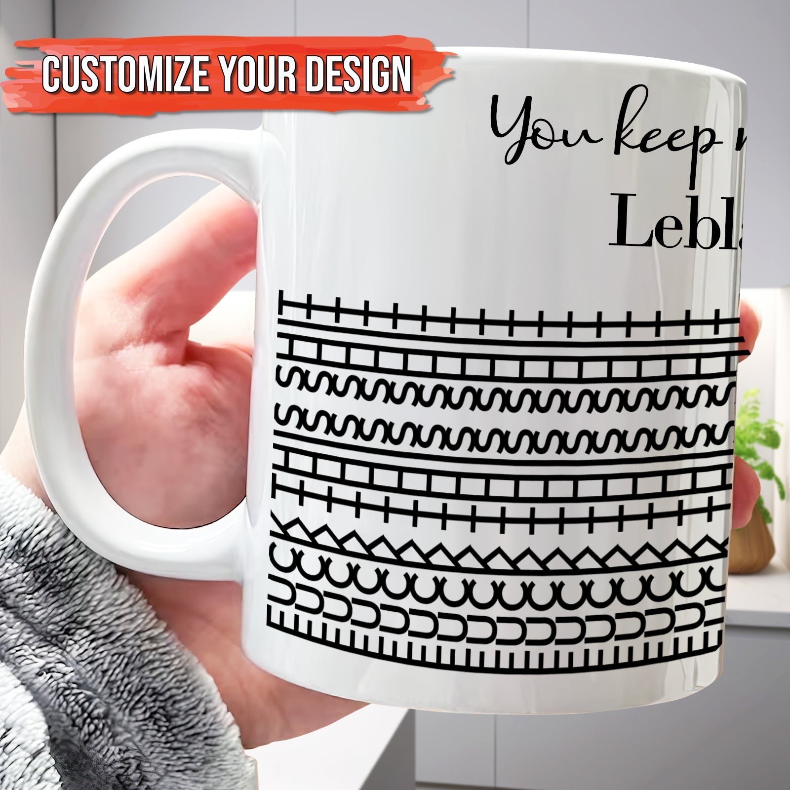 Hand holding 365Gifty white ceramic personalized 'You Keep Me Sane' mug with black geometric stripe pattern