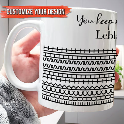 Hand holding 365Gifty white ceramic personalized 'You Keep Me Sane' mug with black geometric stripe pattern