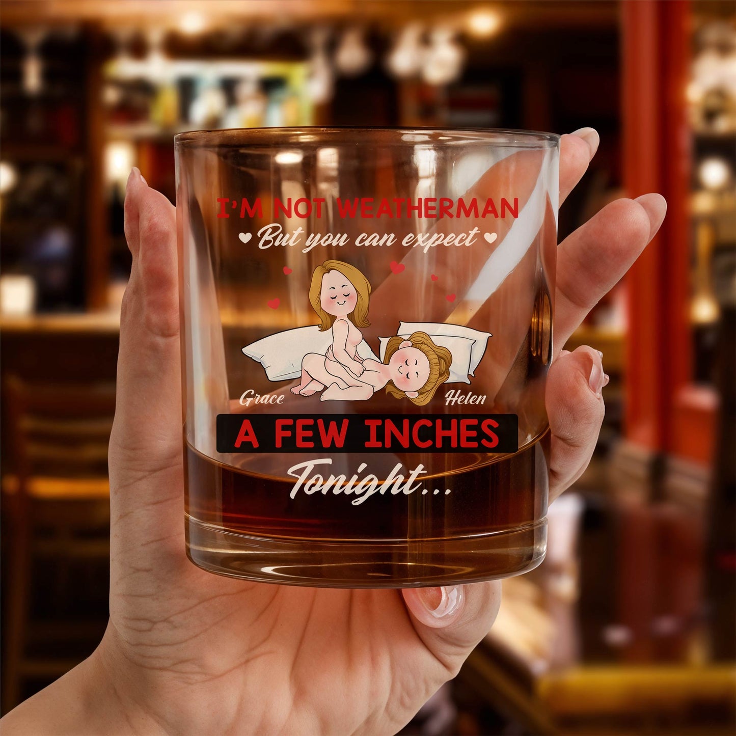 Personalized Whiskey Glass held in hand with amber whiskey showing humorous cartoon women and names Grace and Helen
