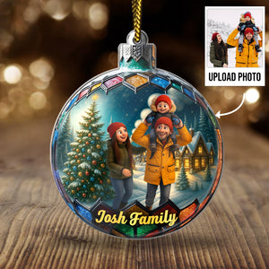 Custom photo Christmas ornament featuring a family with a snowy background and a Christmas tree