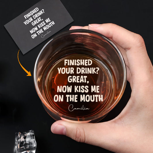 Hand holding personalized whiskey glass for couples engraved with playful finished your drink now kiss me on the mouth text