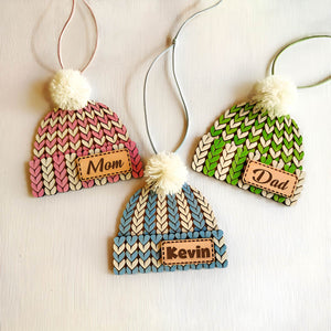 Customizable holiday stocking tag shaped like knit hats with pom poms labeled Mom Dad and Kevin