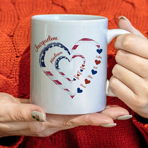 custom first mom now grandma gift white ceramic mug with American flag heart design and personalized names held by woman