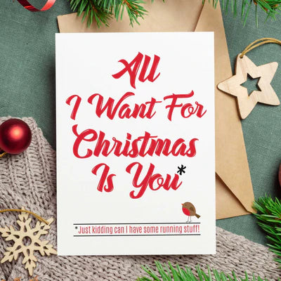 365Gifty bundle cycling Christmas card with red text All I Want For Christmas Is You and holiday decorations