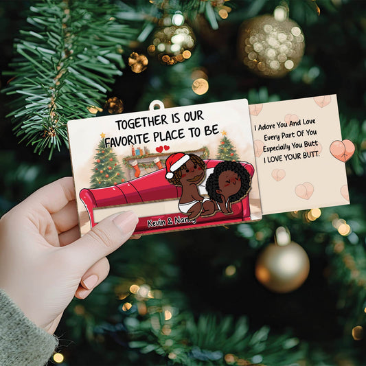 Personalized couple ornament featuring cartoon couple on couch with holiday background and love message