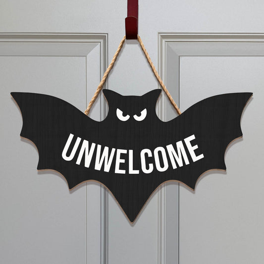 Funny Halloween door sign shaped like a bat with the word UNWELCOME for spooky decorations