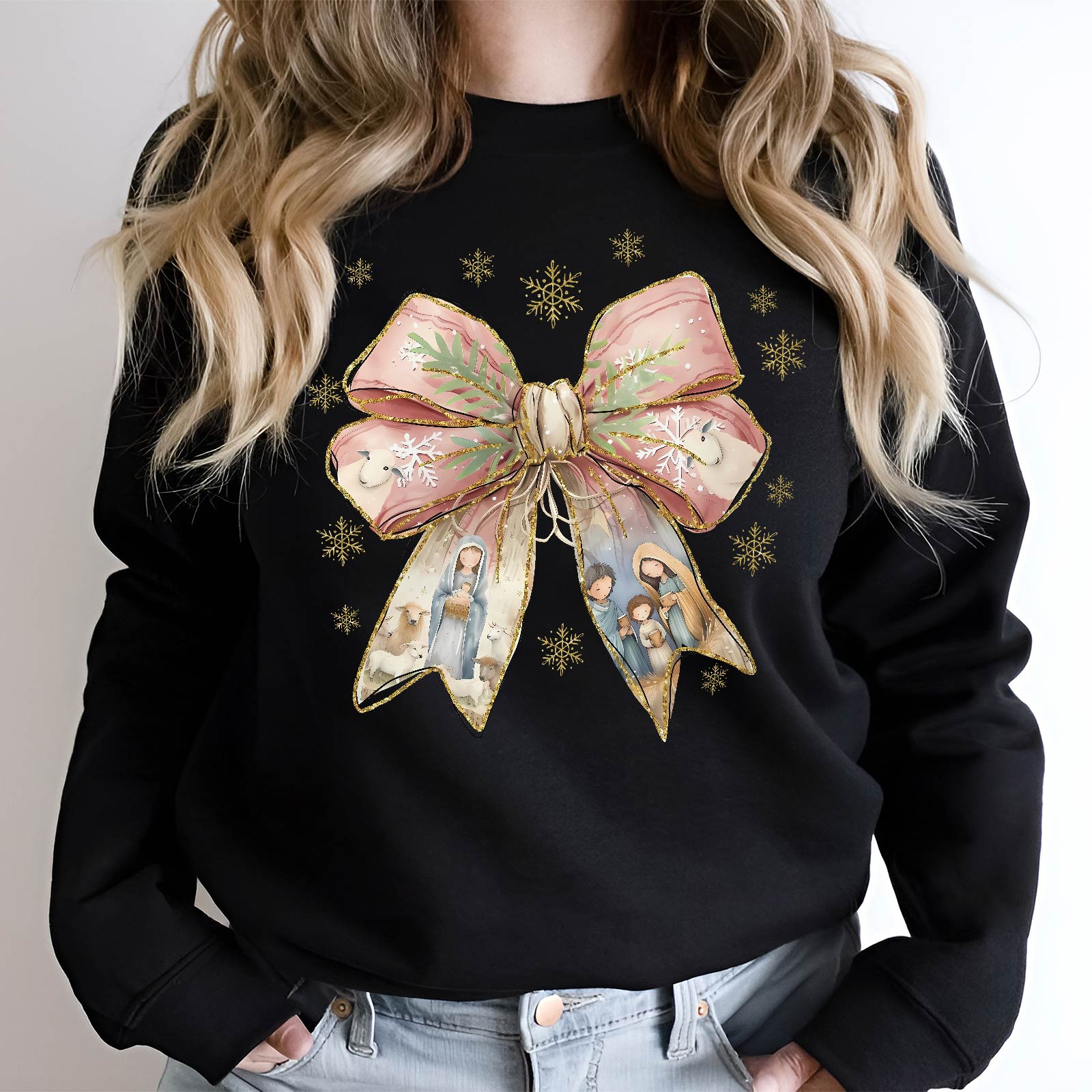 Black sweatshirt featuring a large Jesus Christmas bow shirt design with nativity scenes and gold snowflakes