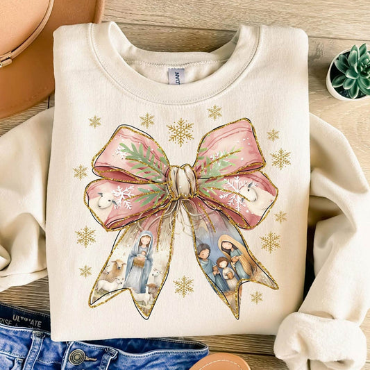 Cream sweatshirt featuring a festive Jesus Christmas bow shirt design with nativity scene and snowflakes