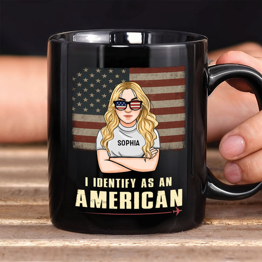 Black ceramic custom I identify as an American mug showing blonde woman with flag sunglasses and vintage US flag background