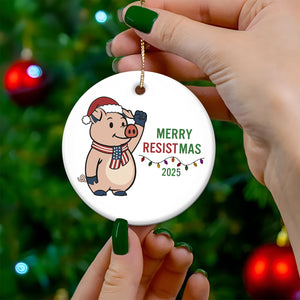 Cute pig wearing a Santa hat on a Merry Resistmas 2025 ceramic ornament for holiday decor