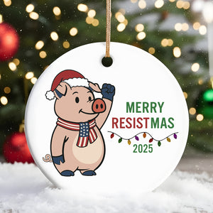 Merry Resistmas 2025 ceramic ornament featuring a cheerful pig wearing a Santa hat and festive lights