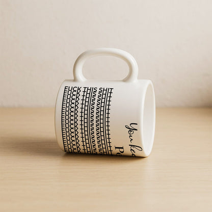 White ceramic personalized 'You Keep Me Sane' mug with black pattern and rounded handle on wooden surface