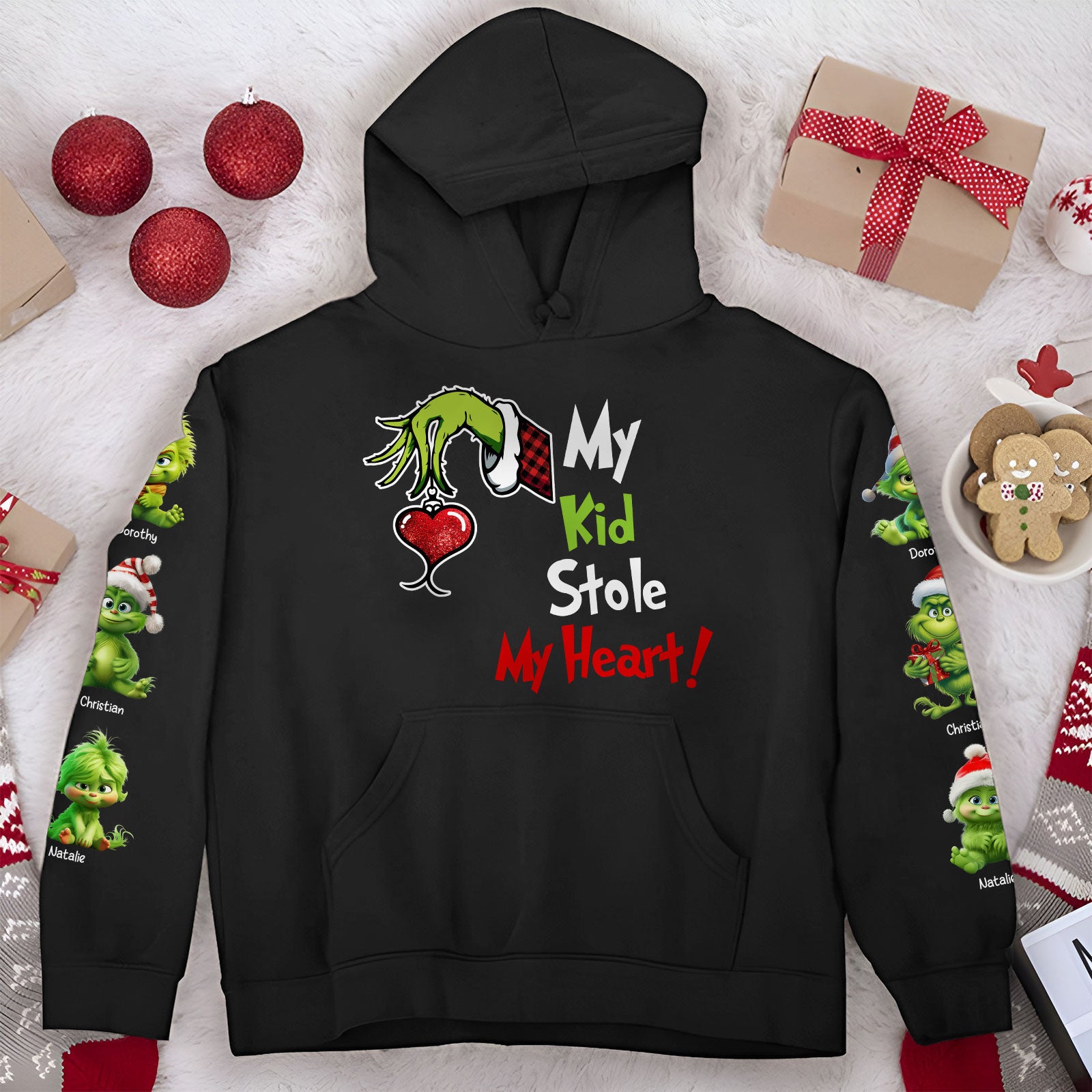 Black hoodie with Grinch hand holding heart and text my kid stole my heart shirt holiday design