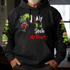 Black hoodie with green Grinch hand holding heart and text my kid stole my heart shirt design