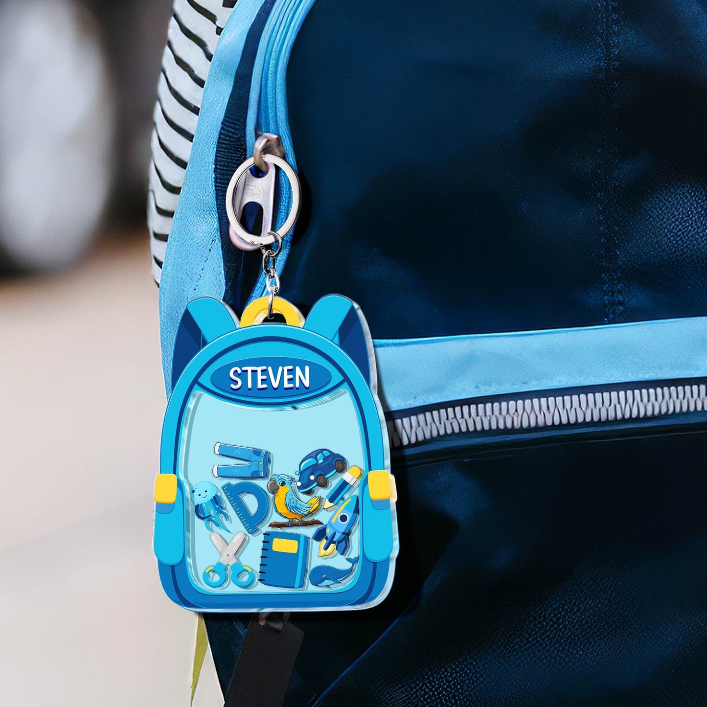 Personalized back to school keychain featuring colorful school supplies on a backpack