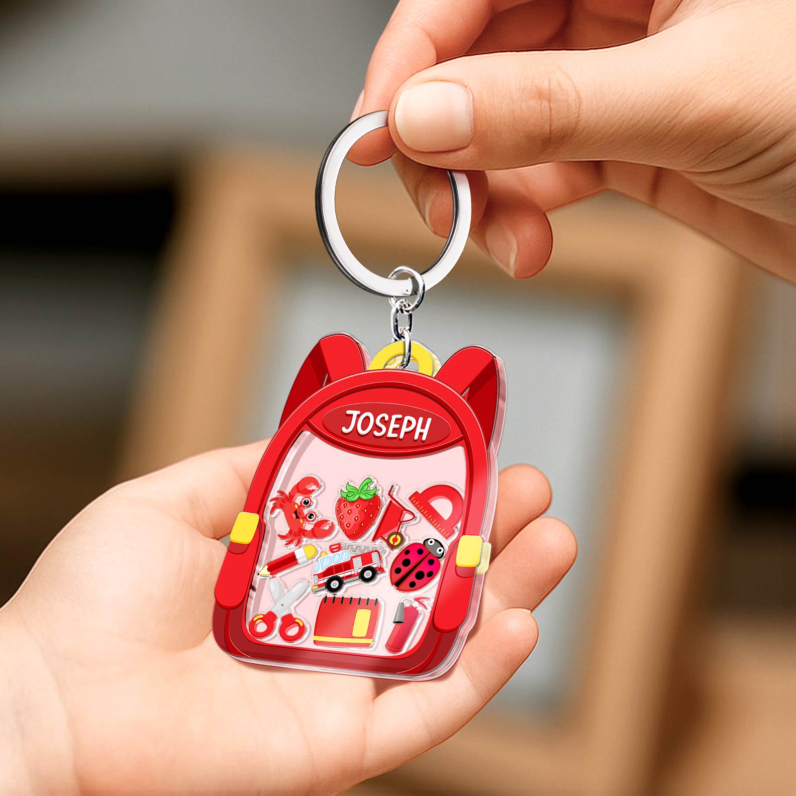 Personalized back to school keychain in red backpack shape with name Joseph and fun school-themed charms