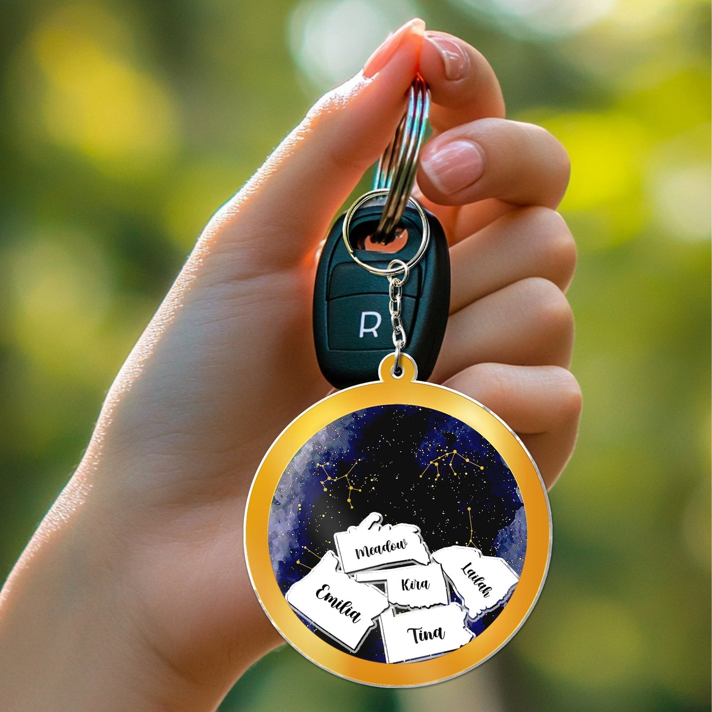 Personalized best friend keychain featuring multiple names on a vibrant starry background