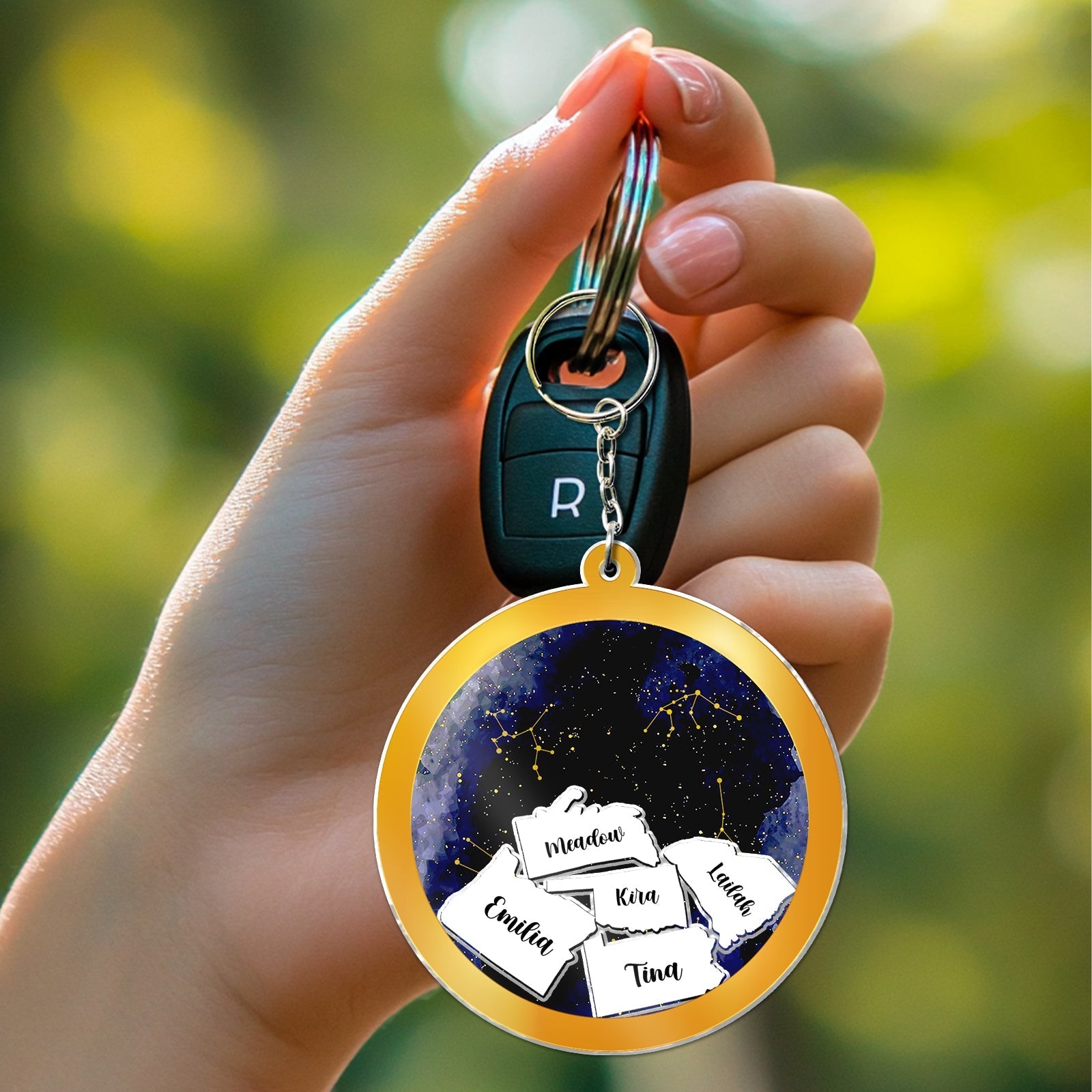 Personalized best friend keychain featuring multiple names on a vibrant starry background