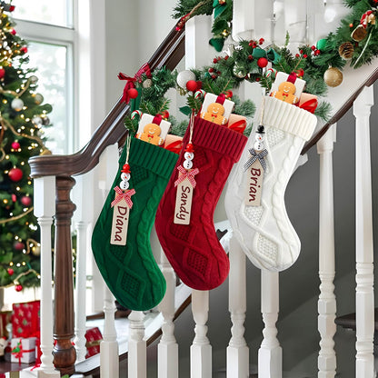 Personalized Christmas stockings in green red and white hanging on staircase with candy and gingerbread decorations