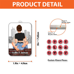 Personalized couple car hanger showing a couple hugging with custom names and charm pieces