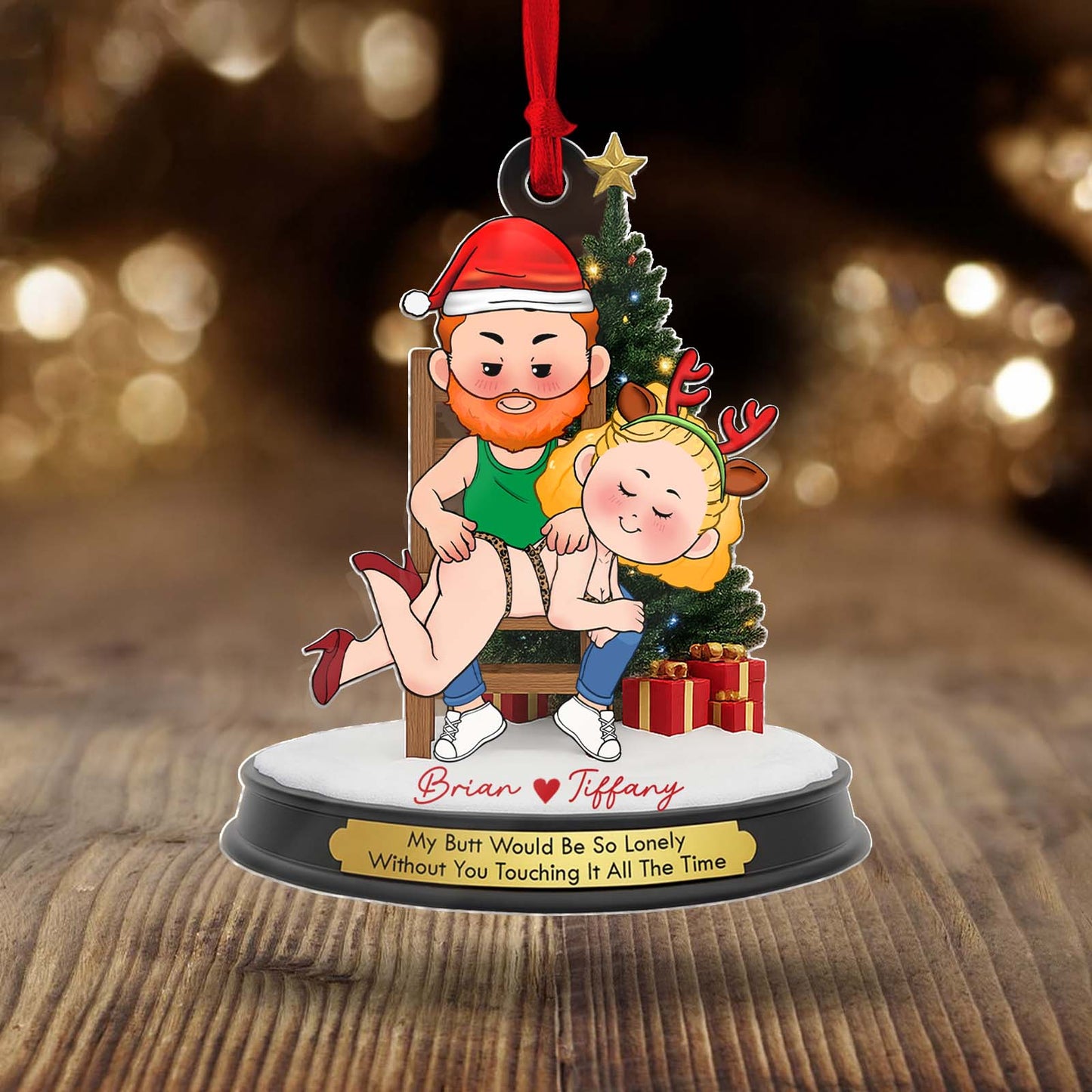 Personalized couple Christmas ornament featuring a cartoon couple with festive attire and playful message