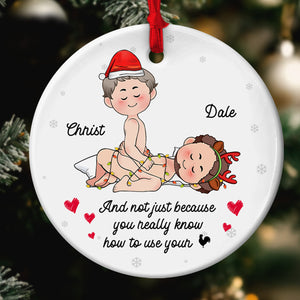 Personalized couple Christmas ornament featuring a playful design with names and festive decorations