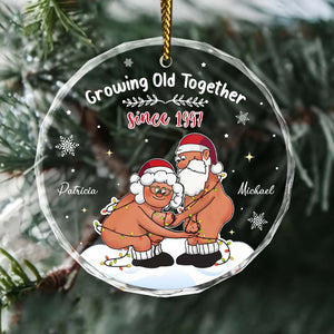 Personalized couple Christmas ornament featuring two cartoon figures with a festive design and names