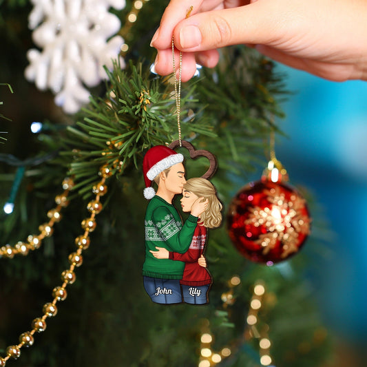 Personalized couple Christmas ornament showing a couple hugging with names John and Lily hanging on Christmas tree