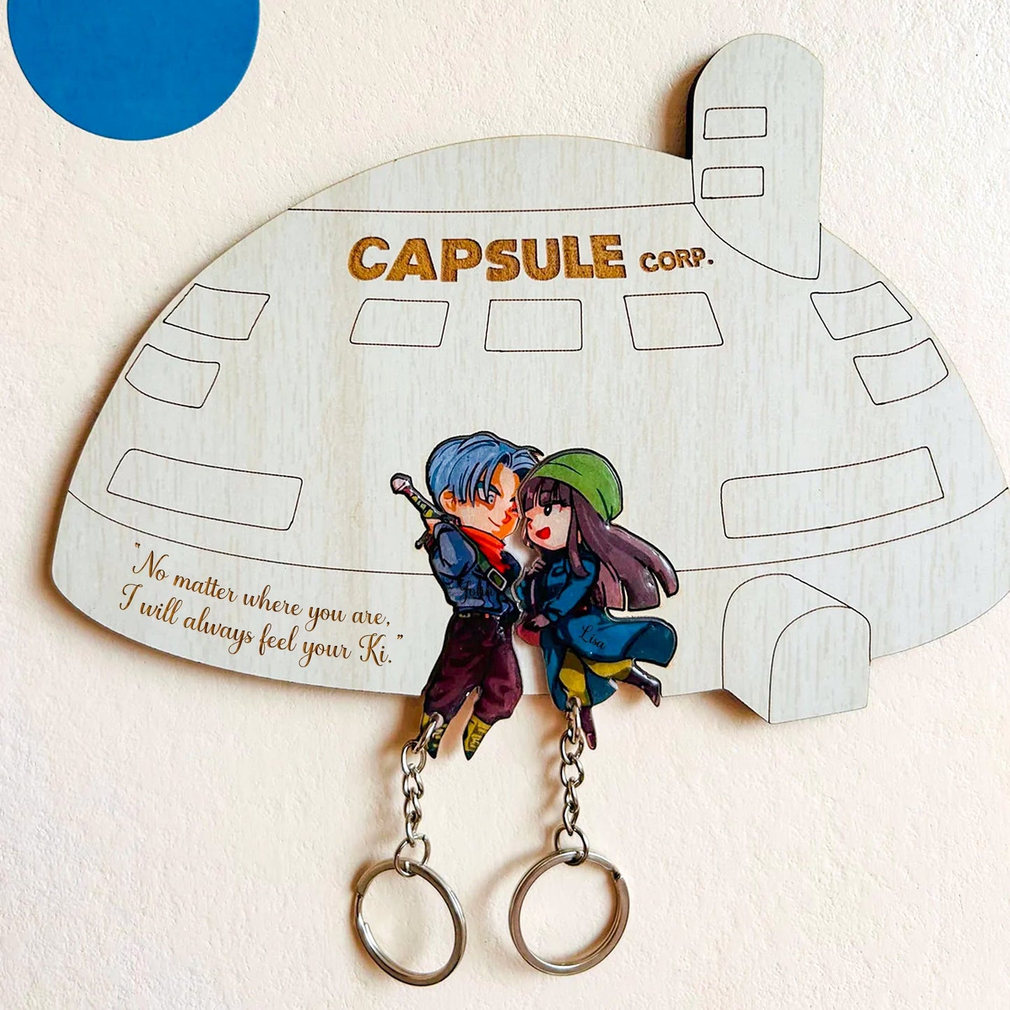Personalized couple key holder designed like Capsule Corp, featuring a romantic cartoon couple and key rings