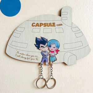 Personalized couple key holder in the shape of a capsule with cute cartoon characters for home organization