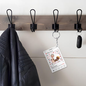 Personalized couple keychain hanging on black hook next to black leather jacket and car key