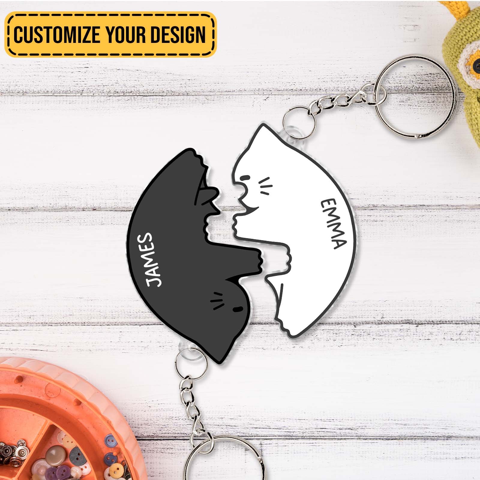 Personalized couple keychain set with black and white cat shapes engraved with names James and Emma