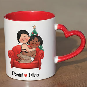 Personalized couple mug featuring cute illustration of Daniel and Olivia on a red couch with a heart handle
